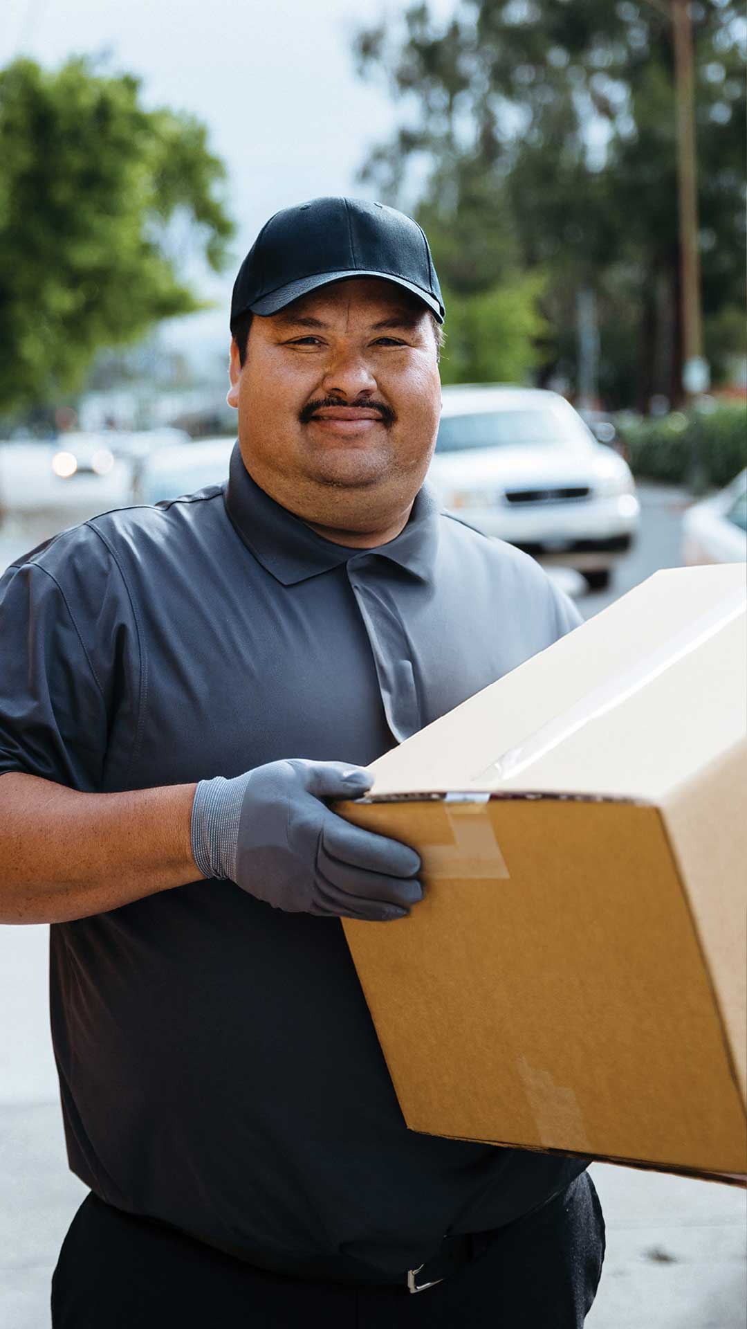 Employee carrying a box of Traditions Frozen Meals