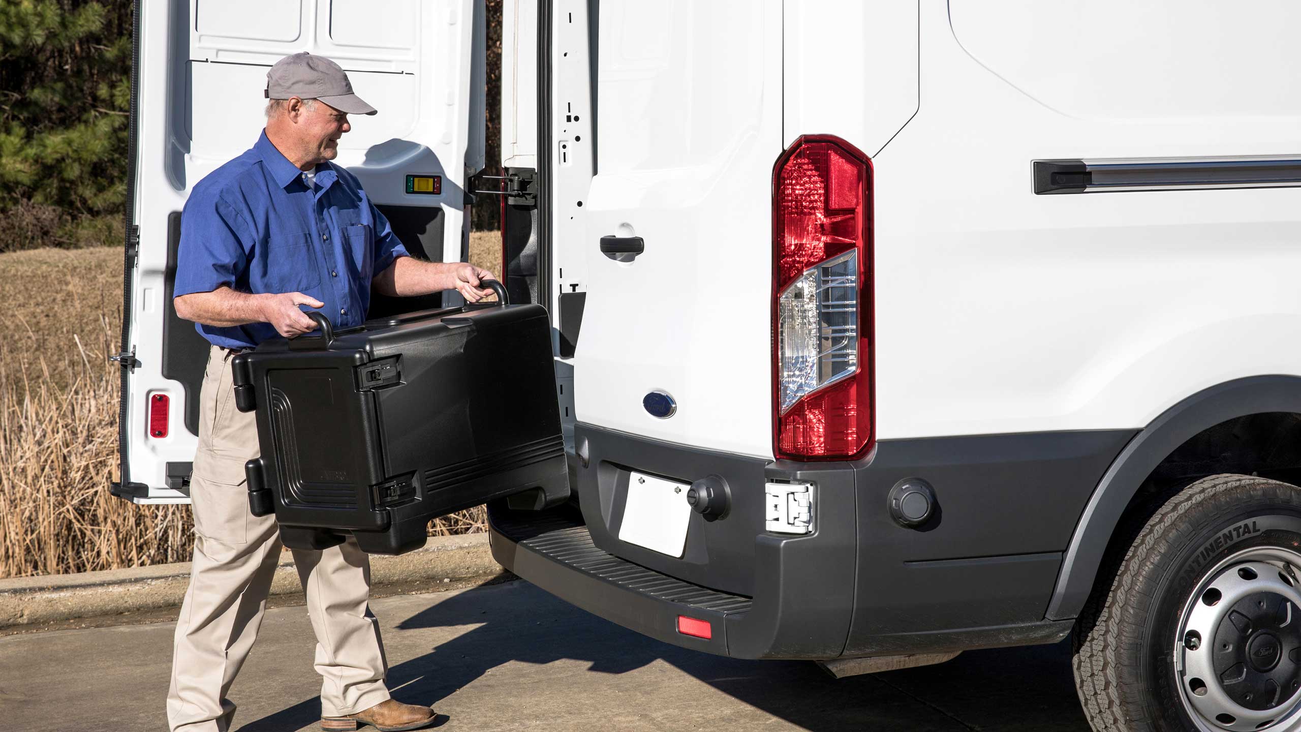 Driver loading up Traditions Meals into back of van to distribute